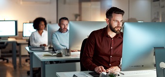 Man sat at a desk in a modern office