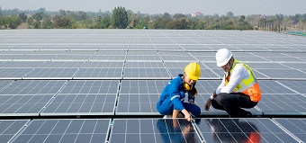 Two workers in the energy sector review solar panels